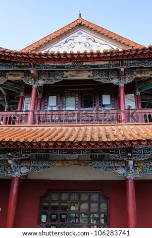 Side elevation of an ancient Chinese style building with colorful paintings.