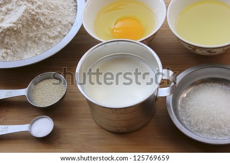 Materials of milk bread -- flour, egg, melted butter, yeast, salt, sugar and milk.