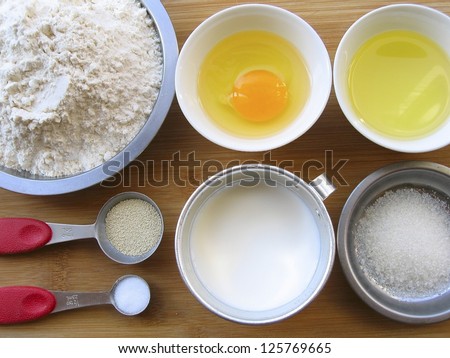 Materials of milk bread -- flour, egg, melted butter, yeast, salt, sugar and milk.