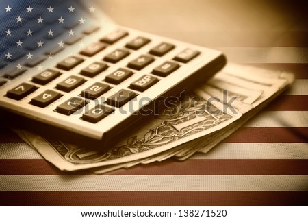Calculator, dollars and USA flag. Sepia image.