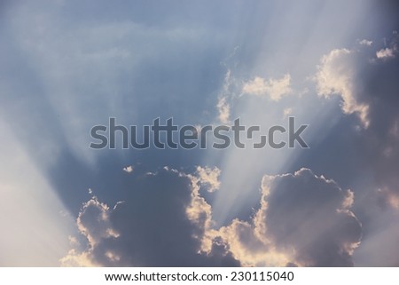 Beam of sunlight through clouds background.