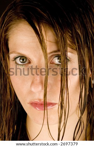 A young woman with wet hair against a plain background.