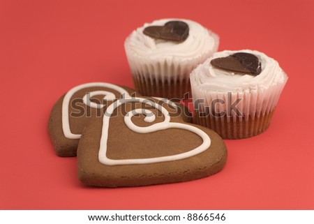 Love heart Cookies and cakes isolated on a Red Background.