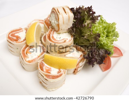 A dish of Salmon and soft cheese wraps