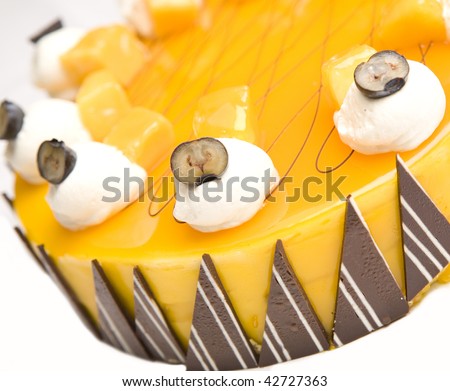 A portion of Mango cheesecake isolated on a white background.