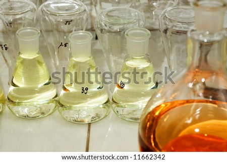 Many different flasks with liquid in chemistry lab