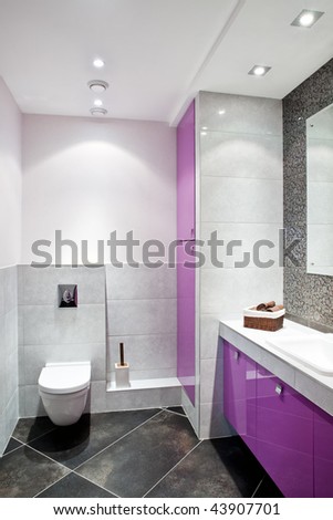 Interior of a new modern domestic room with black and white tiles and purple furniture