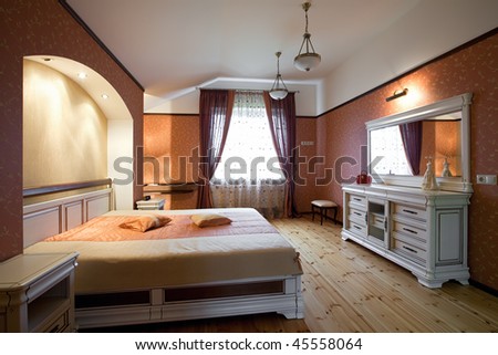 Interior Of Beautiful Bedroom With White Wooden Furnitu