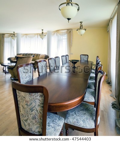 Interior of living room with big table for dinner