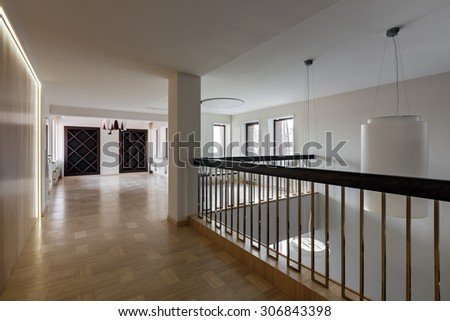 Interior of modern empty space with closet, handrail and windows