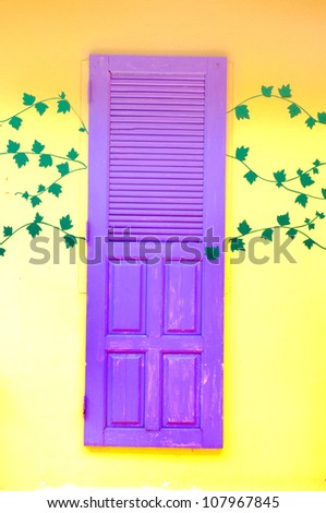 purple door on wall yellow