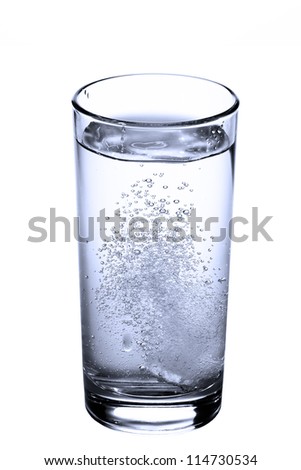 tablet in glass of water isolated on white