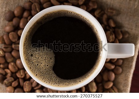 top view of a freshly brewed Cup of black French coffee fabric from jute