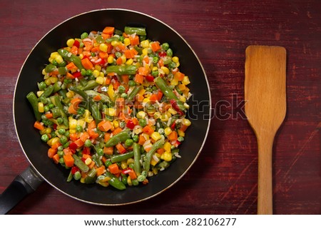 vegetable mix in the pan on wooden background