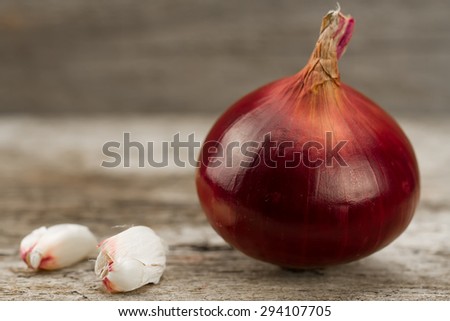 fresh red onions on wooden background, macro