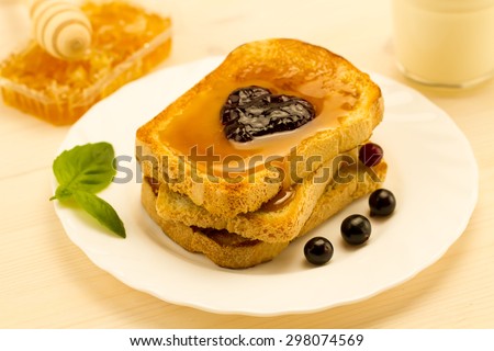 fresh french toast with honey and jam on a white plate with berries. healthy diet