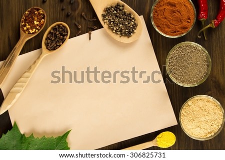 sheet old vintage paper with spices on wooden background. Healthy vegetarian food. Recipe, menu, mock up, cooking.