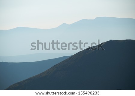 Abstract mountain scene as the morning mist creates layers in the mountains.