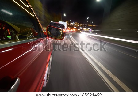 A driver stuck in a traffic jam on a busy road at night.