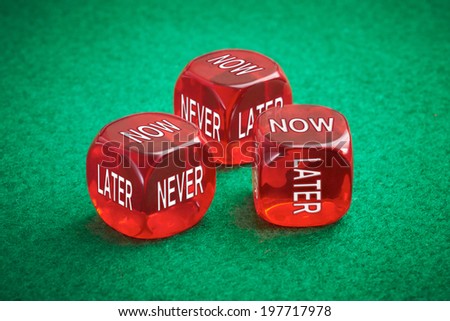 Wasting time concept, three red dice on a green felt background.