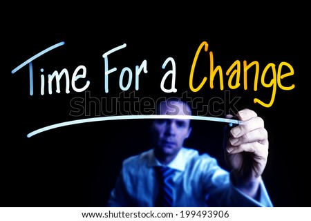 A businessman drawing a Time for Change concept on a glass screen.