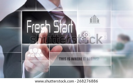 Businessman pressing a Fresh Start concept button.
