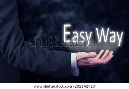 The arm of a businessman holding the words Easy Way.