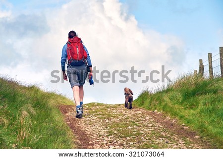 A woman out walking in the English countryside.
