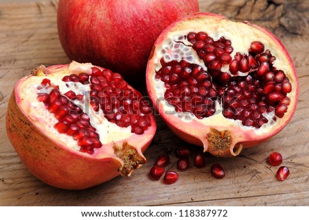 Pomegranate fruits on rustic wood background.Winter fruits.