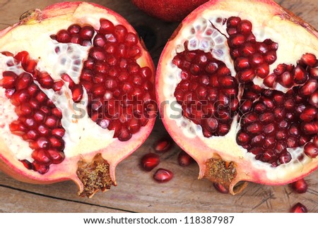 Pomegranate fruit rustic on wood background. Winter fruits.