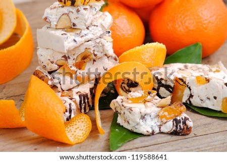 Nougat with nuts, candied orange peels and chocolate. Typical italian sweets.