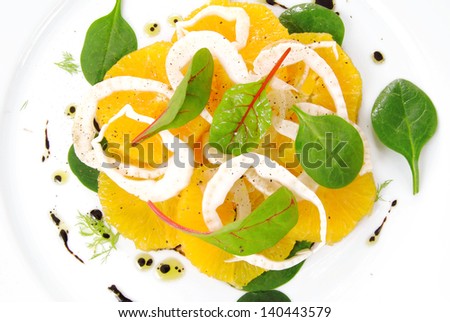 Fennel and orange citrus salad, on white plate.Modern, light, raw, veg cuisine.Winter salad.