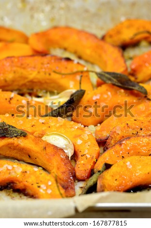 Tray with baked butternut squash and herbs.Roasted vegetables healthy food.