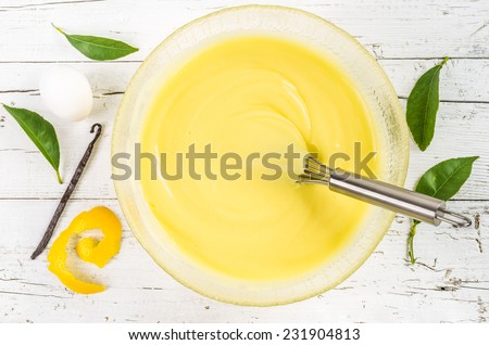 Custard pastry cream on white wood background. Preparation of sweet pastry cream in a bowl.Pastry filling.