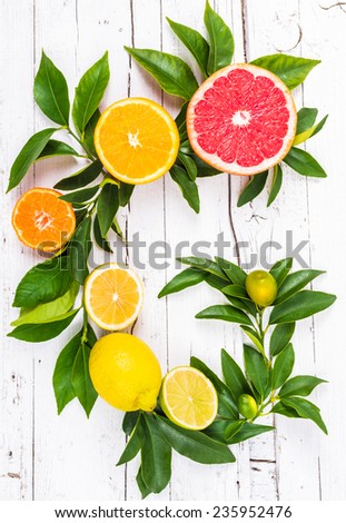 Fresh citrus fruits on white wood background. Vitamin c fruits.