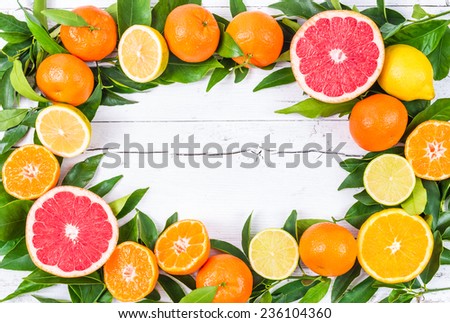 Fresh citrus fruits on white wood background.Frame for text message.