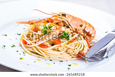 Plate with seafood spaghetti, pasta.Italian restaurant menu plate, noodles with prawns, langoustines, lobster.Italian food background.