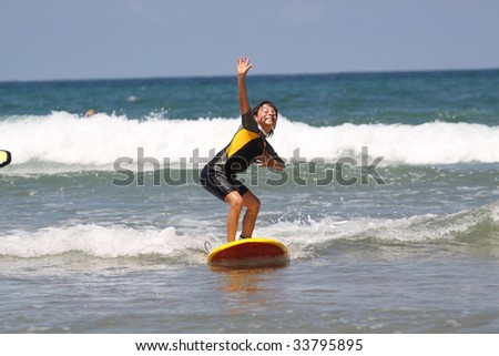 Young boy learning to surf