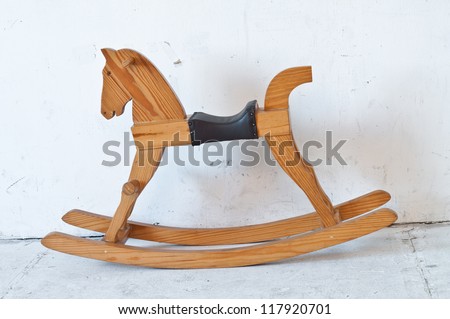 Small Antique brown wooden rocking horse toy.