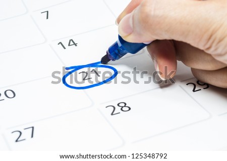 Blue circle. Mark on the calendar at 21. - stock photo