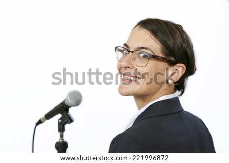Sucssesful businesswomen keynote speaker in front of microphone before public speaking
