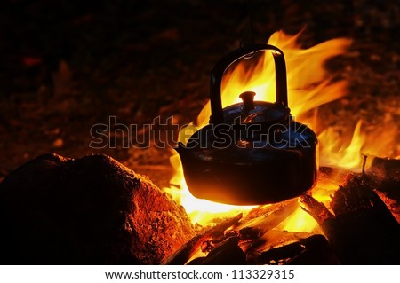 Camping kettle on the fire at an outdoor campsite Kettle for coffee while camping.in Angthong national marine park