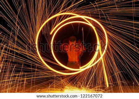 Fire show a circular motion. Fire show amazing at night