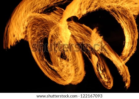 Fire-show man in action with fire  Fire show a circular motion.