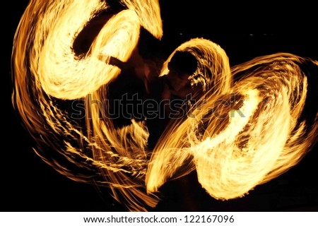Fire-show man in action with fire  Fire show a circular motion.