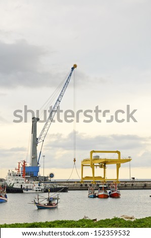 Crane for lifting a load up and down the ship. In deep water harbor area of Thailand