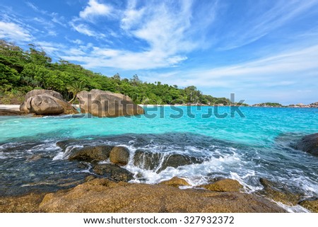 Beautiful landscape of blue sky sea and white waves on beach near the rocks during summer at Koh Miang island in Mu Ko Similan National Park, Phang Nga province, Thailand