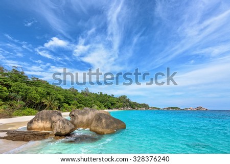 Beautiful landscape of blue sky sea sand and white waves on beach near the rocks during summer at Koh Miang island in Mu Ko Similan National Park, Phang Nga province, Thailand