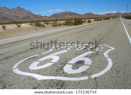 long road with a Route 66 sign painted on it