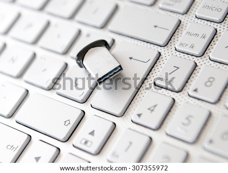 Close up on black letters on white pc computer keyboard and pen-drive